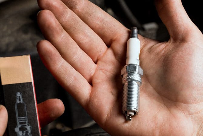 Show spark plug in hand